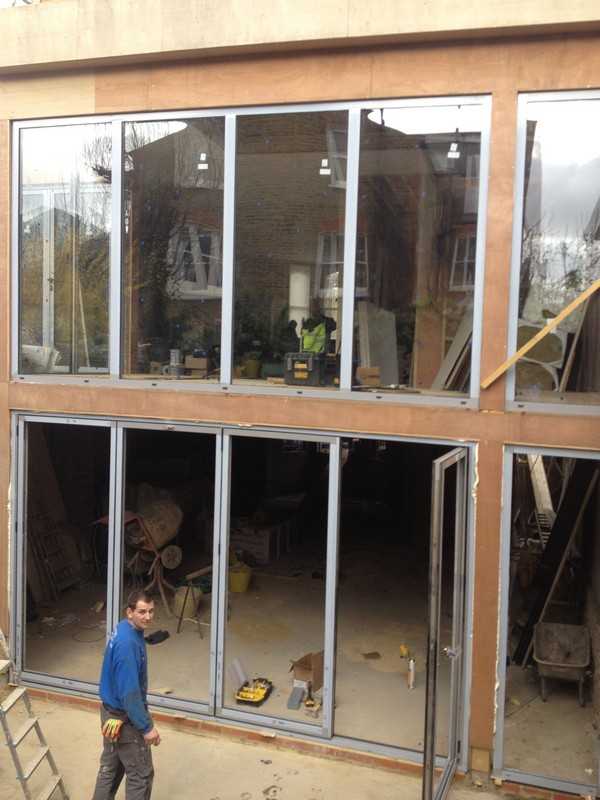 Aluminium bi-fold doors with two-storey glazing in Northolt