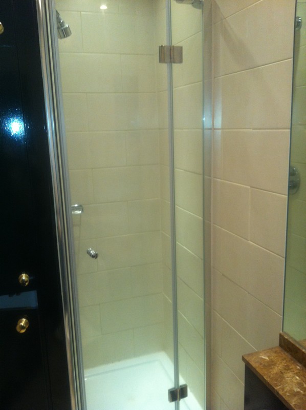 Frameless glass shower enclosure with chrome fittings in Northolt