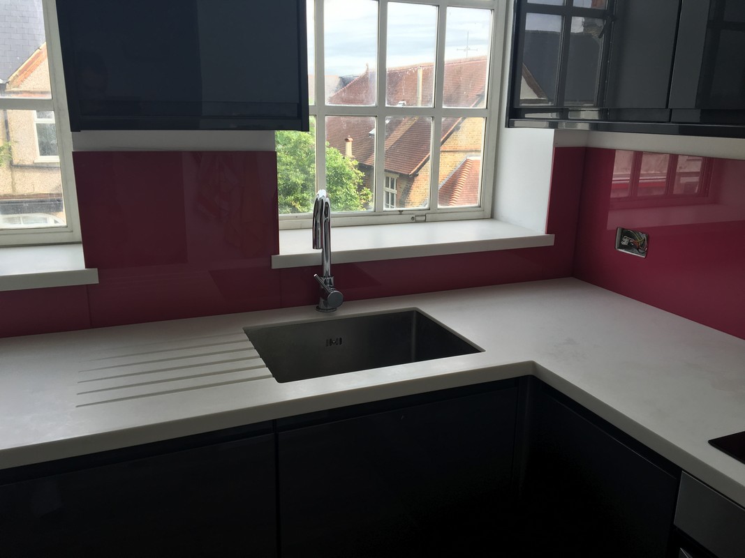 Deep plum coloured glass splashback in modern Northolt kitchen